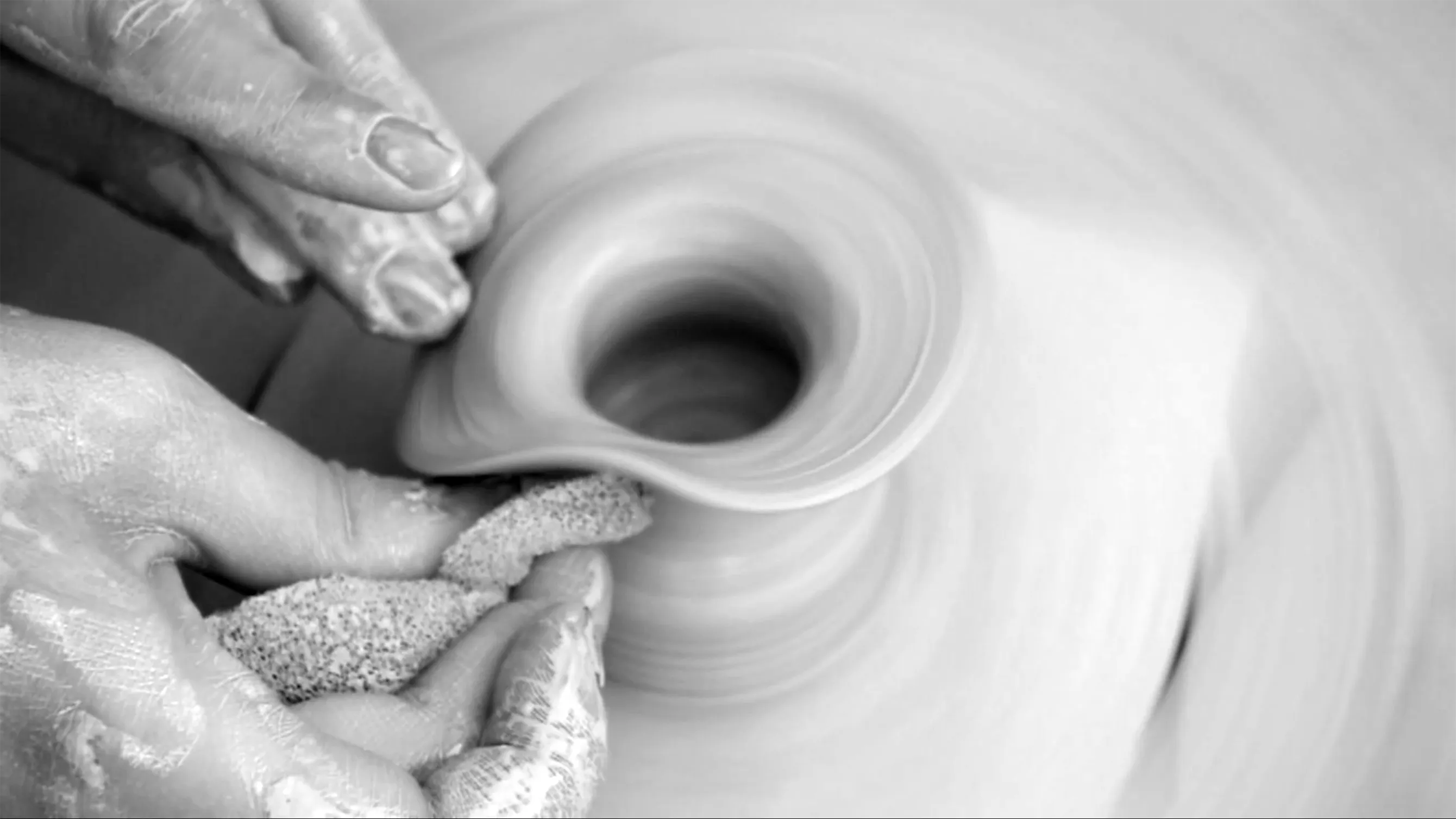 Close-up of my hands working a vessel on the wheel.